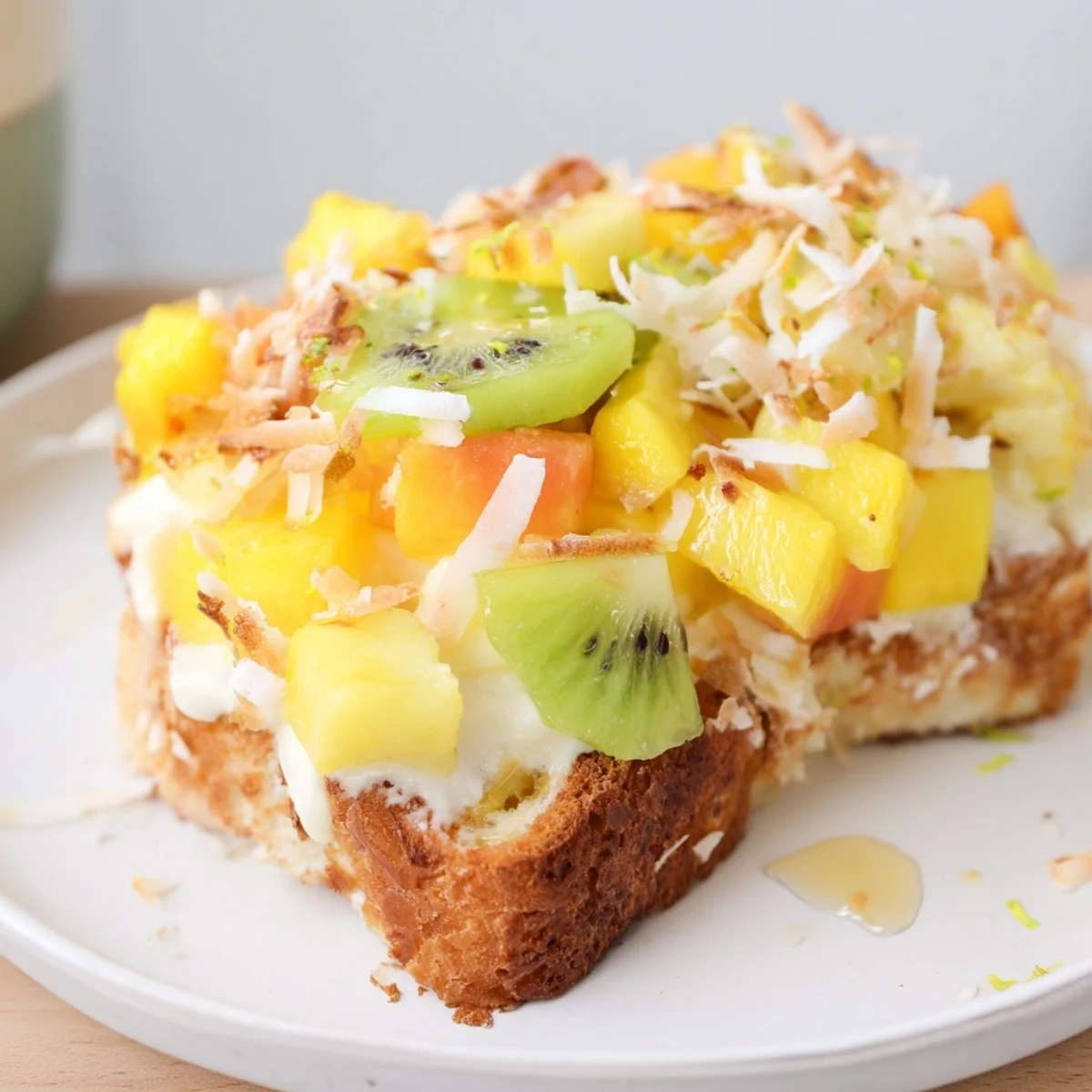 Delicious yogurt-custard toast, garnished with tropical fruits and shredded coconut flakes.  