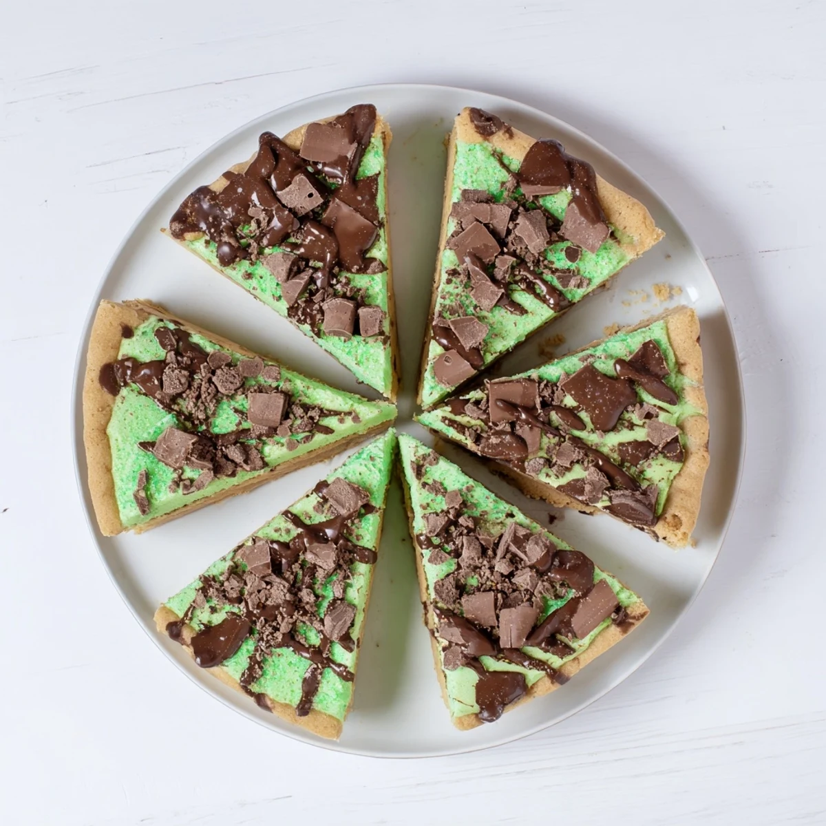 Chocolate peppermint shortbread wedges, drizzled with glossy chocolate, ready for a sweet bite.