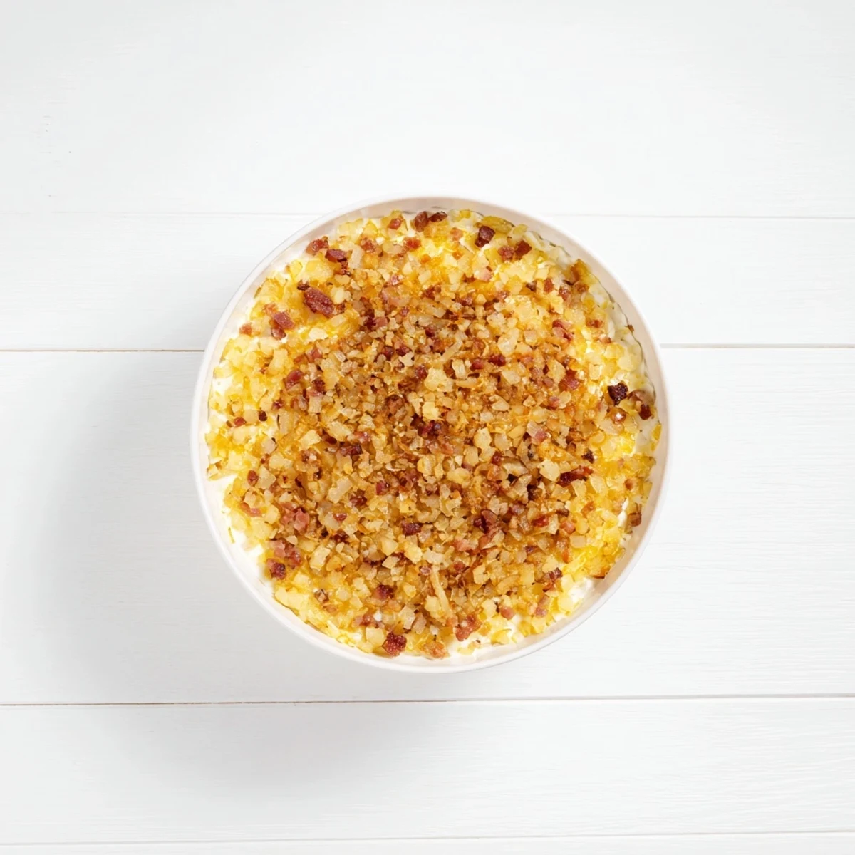 Golden caramelized onion and bacon dip, a creamy appetizer, ideal for dipping chips.