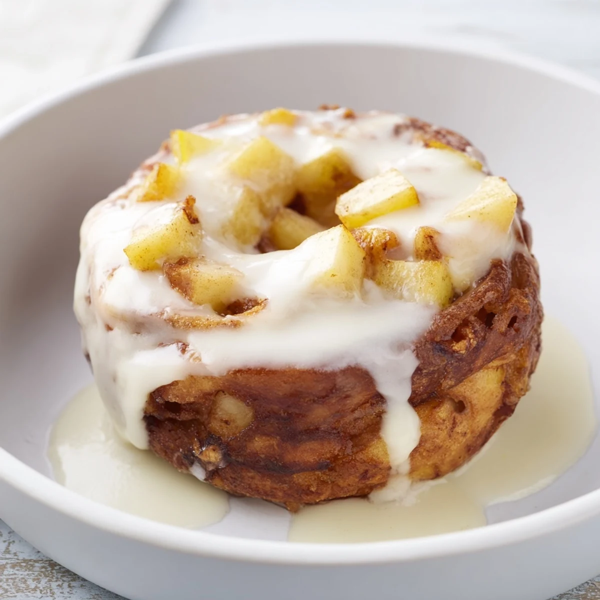 Freshly made apple fritters, bursting with cinnamon scents and tender apple chunks, ready to enjoy.