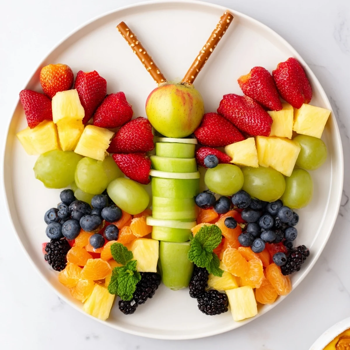 A visually stunning Butterfly Fruit Tray, showcasing fresh fruit for a healthy appetizer, ready to enjoy.