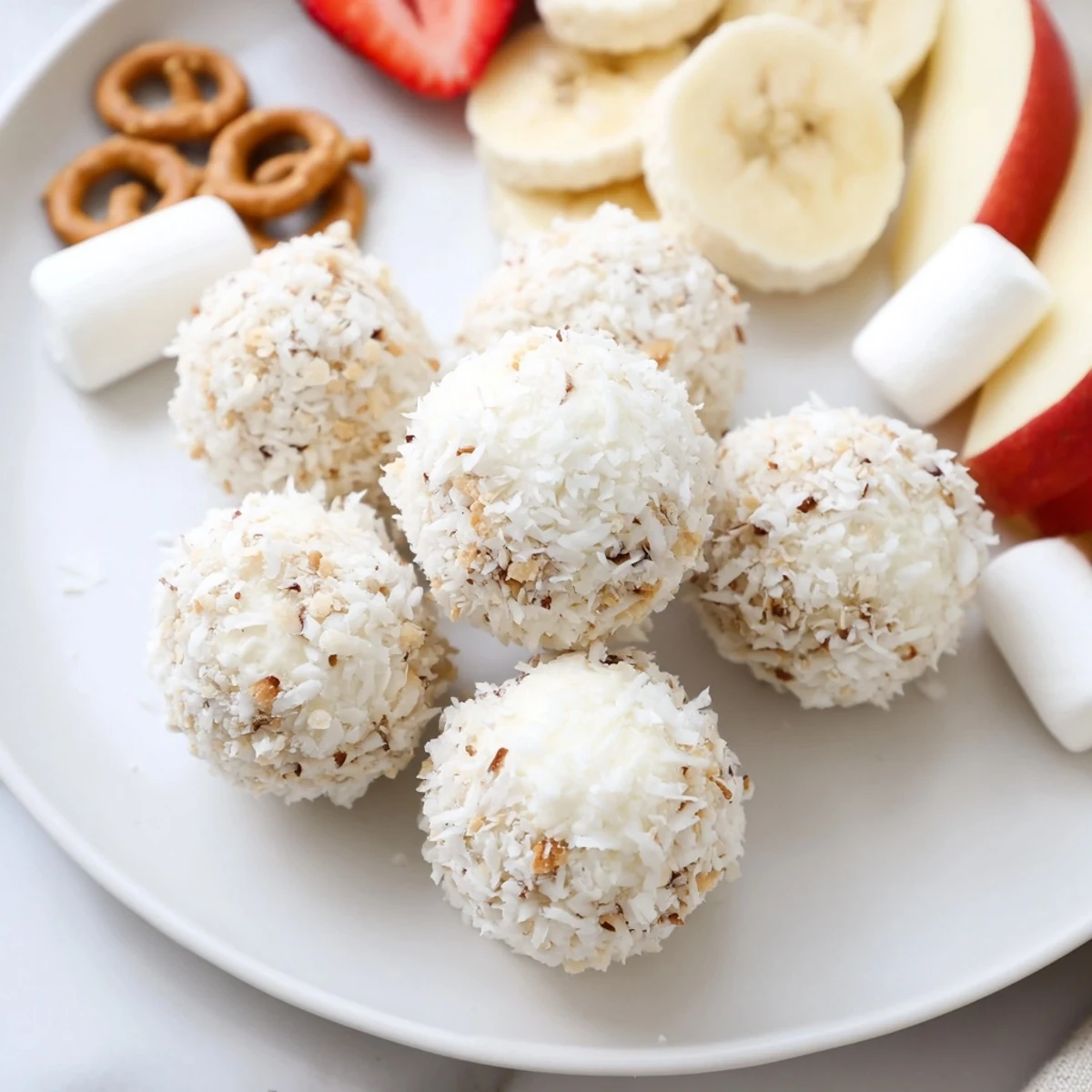 Marshmallow Snowball Dip Platter, a delightful dessert featuring creamy snowball-like confections with fruit.