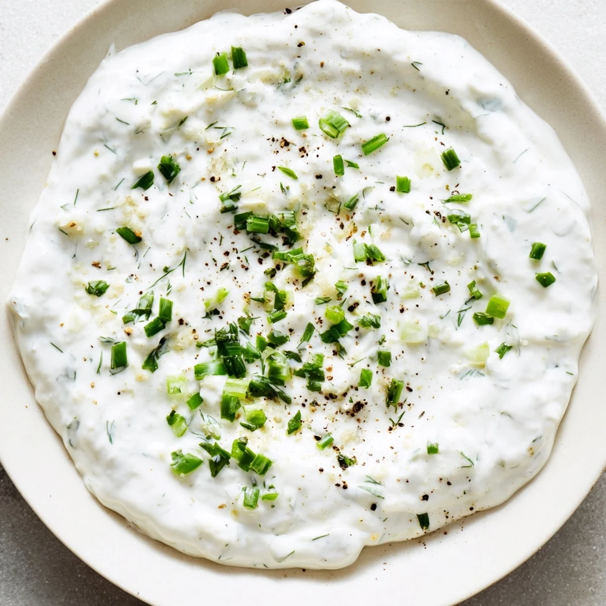 Homemade Greek Yogurt Ranch Dip, a healthy and light appetizer, brimming with fresh herbs for serving.