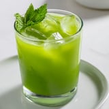Bright green Celery Ginger Lemon Juice served in a mason jar, a refreshing morning reset with a mint sprig.