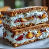 Delicious homemade frozen peach yogurt sandwiches stacked, ready for a refreshing summer dessert.