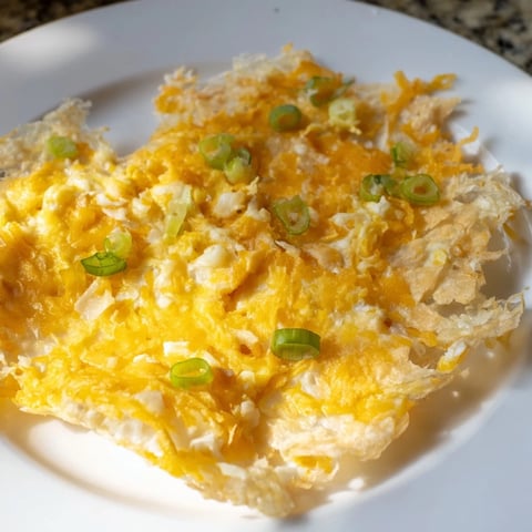 Golden, crispy Rice Paper Egg & Cheese Fold, a quick breakfast with melted cheese and fresh scallions inside.