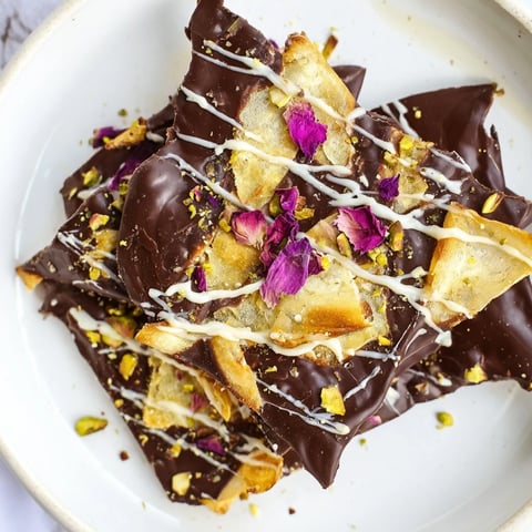 A close-up shot of rich Pistachio Dubai Chocolate Bark with flaky phyllo and crunchy pistachios.