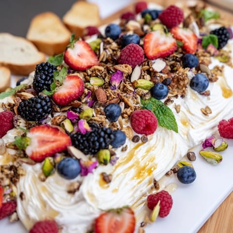 Lush Butter Board Dessert spread with cream cheese, berries, and crunchy toppings.  