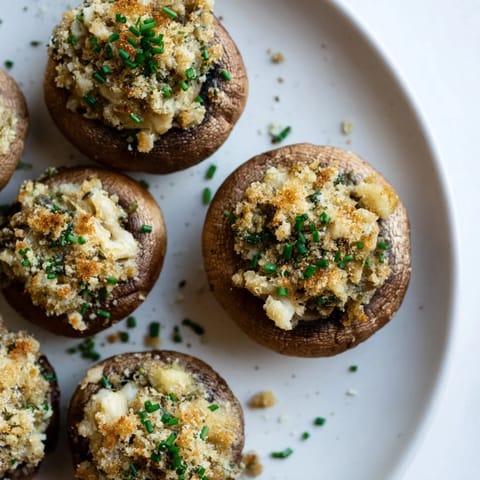 Close-up of baked Enchanted Forest Mushroom Nibbles, filled with herbs, ready to be enjoyed.