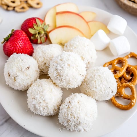 Get ready for a delicious Marshmallow Snowball Dip Platter, perfect for festive parties with fruit and biscuit dippers.