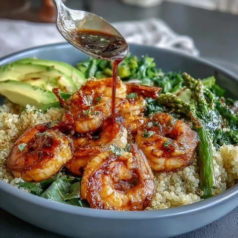 Flavorful Detox Buddha Bowl featuring tender shrimp, quinoa, and crisp vegetables drizzled.