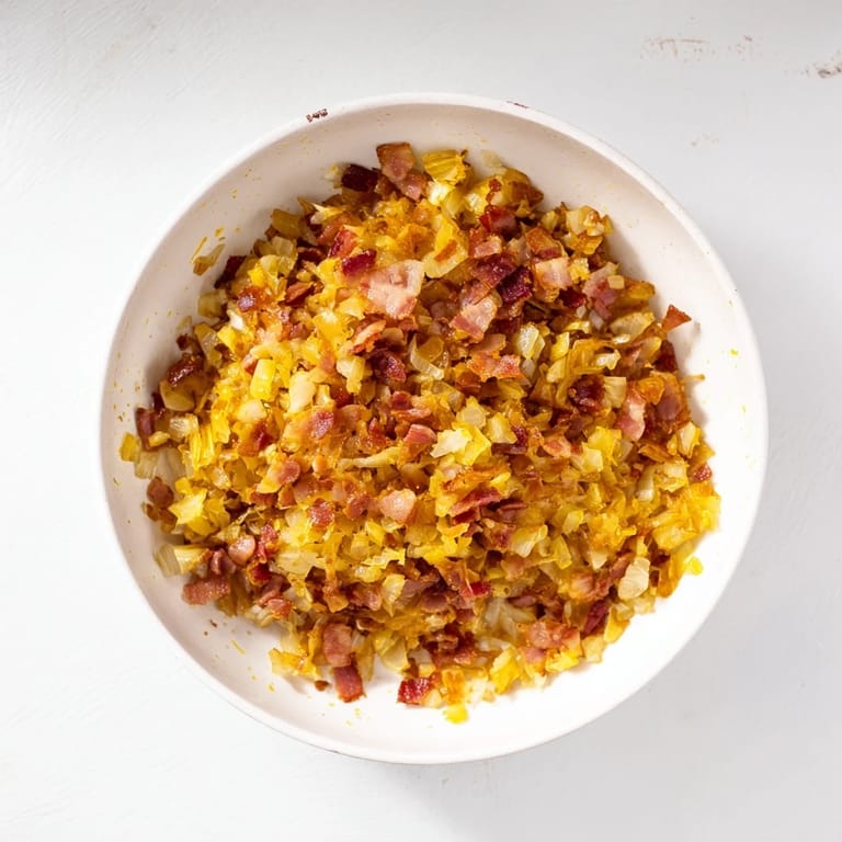 Smoky bacon and sweet caramelized onion dip, ready to be served, chilled and flavorful.