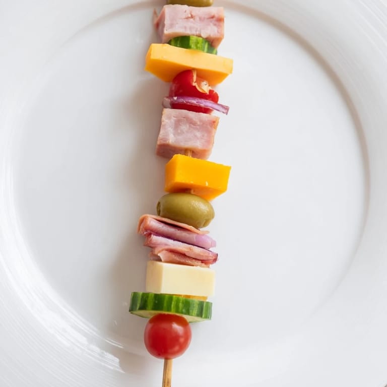 Freshly made Savory Skewers present a delicious mix of turkey, Swiss cheese, and cherry tomatoes.