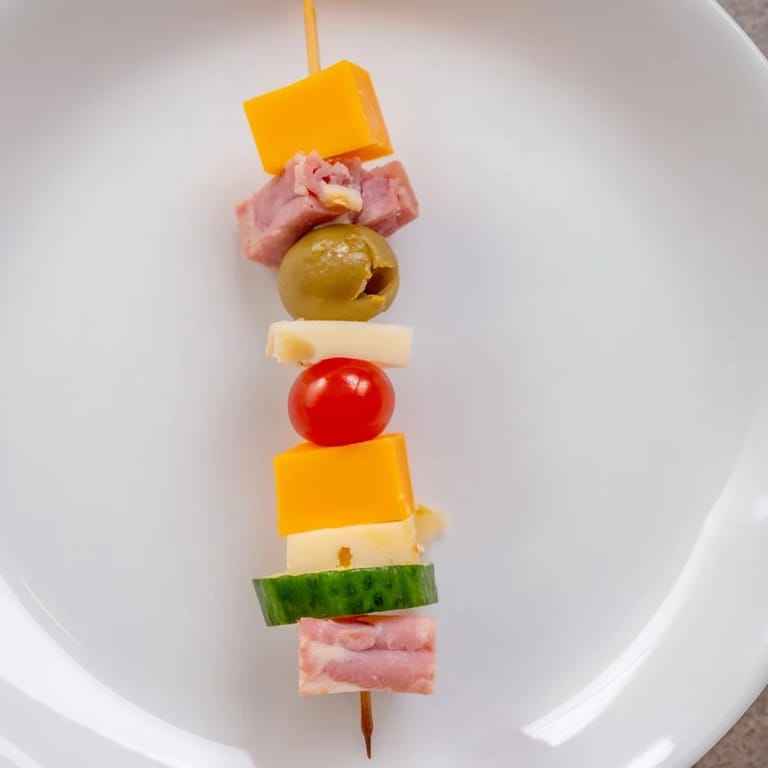These easy Savory Skewers mingle savory ham, cheddar, and tangy pickles for a perfect appetizer.