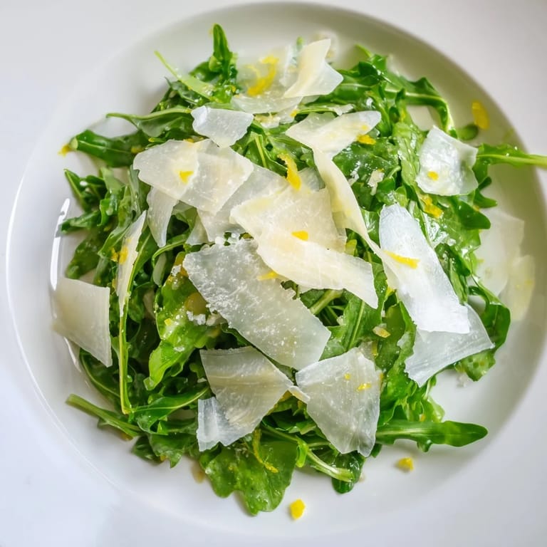 This quick arugula salad, coated in zesty lemon dressing, showcases peppery greens and creamy Parmesan.