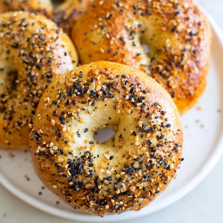 Close-up of fluffy homemade Everything Bagel Yogurt Bagels, enticingly topped and perfect for a quick breakfast.